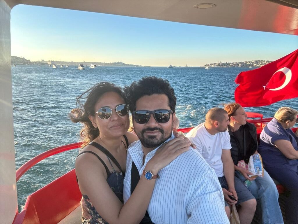Tushar and Sanju on a boat on the Bosphorus with a Turkish flag