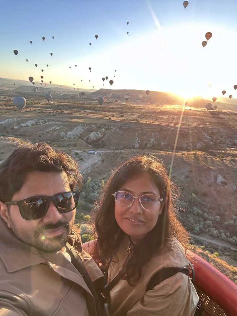 Tushar and Sanju taking a selfie in the balloon basket at sunrise