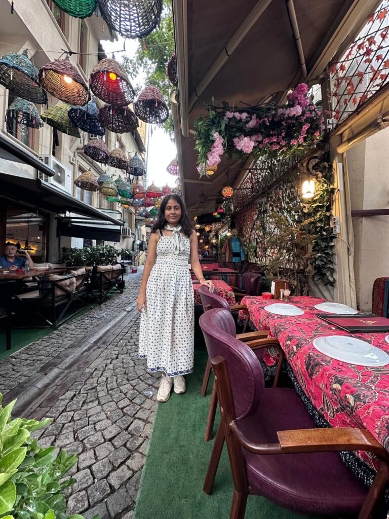 Sanju on a restaurant street in Sultanahmet with hanging wicker lamps